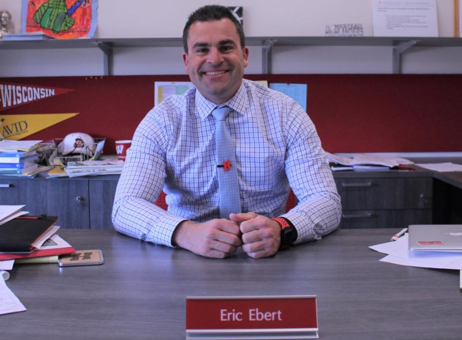 Principal Ebert sits at his desk.