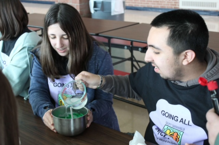Angel Simental makes slime with his group of members during the meeting at the end of Best Buddies Week.