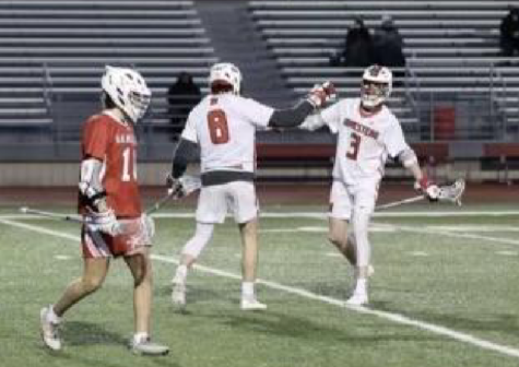 Sean West, junior, high-fives teammate at a game.