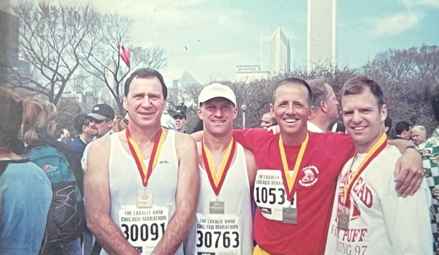 John Chekouras, Ernie Millard, Steven O’Brien, and their roommate pose for a photo after the Chicago Marathon, grin from ear to ear at the Chicago Marathon. 