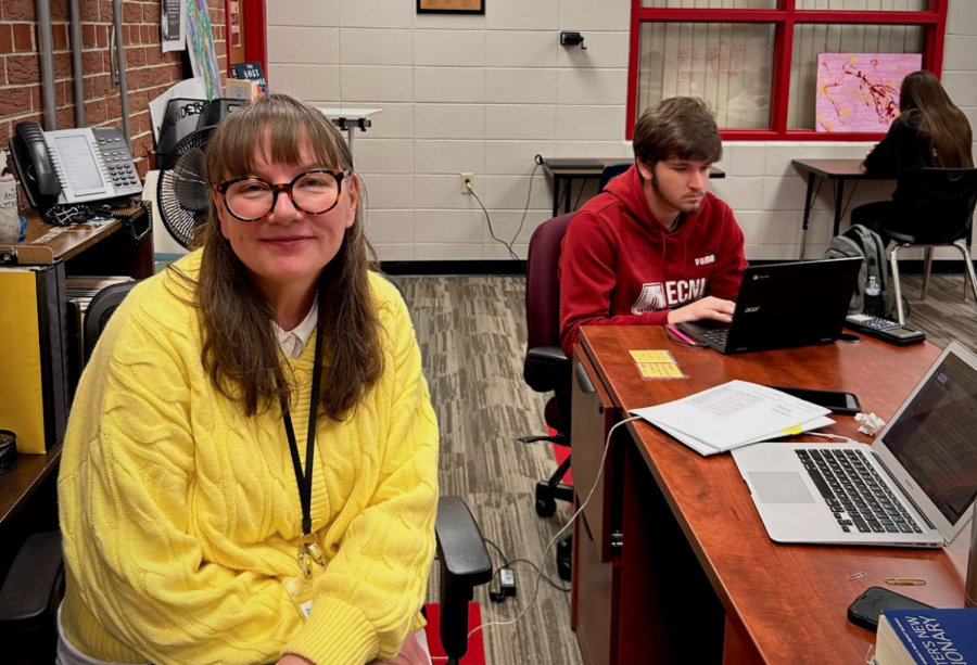 Elizabeth Noorlander sits at her desk while students work.