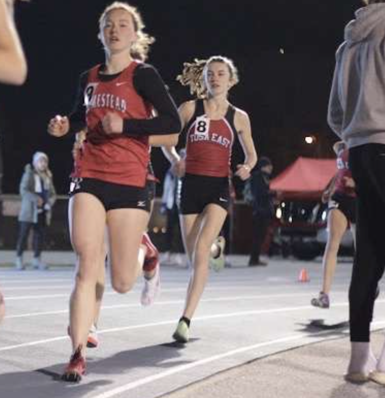 Savannah Fraley runs around the curve of the track during her 1-mile run. 