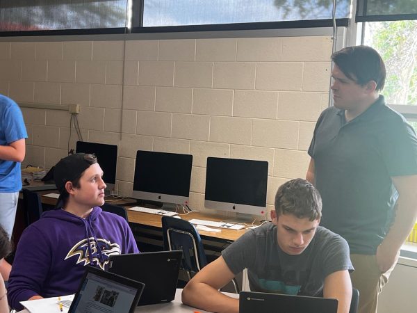 Nick Marsh helps student come up with ideas in computer science class.