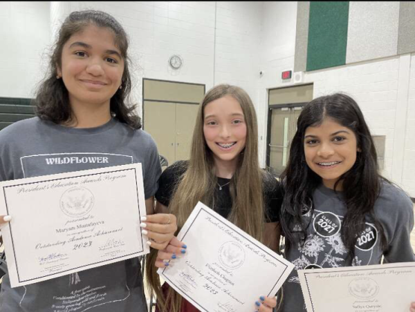 Elizabeth Chagnon (center), freshman, at her middle school promotion award ceremony with Myram Mustafayeva (left), and Safiya Quryshi (right), freshmen.
