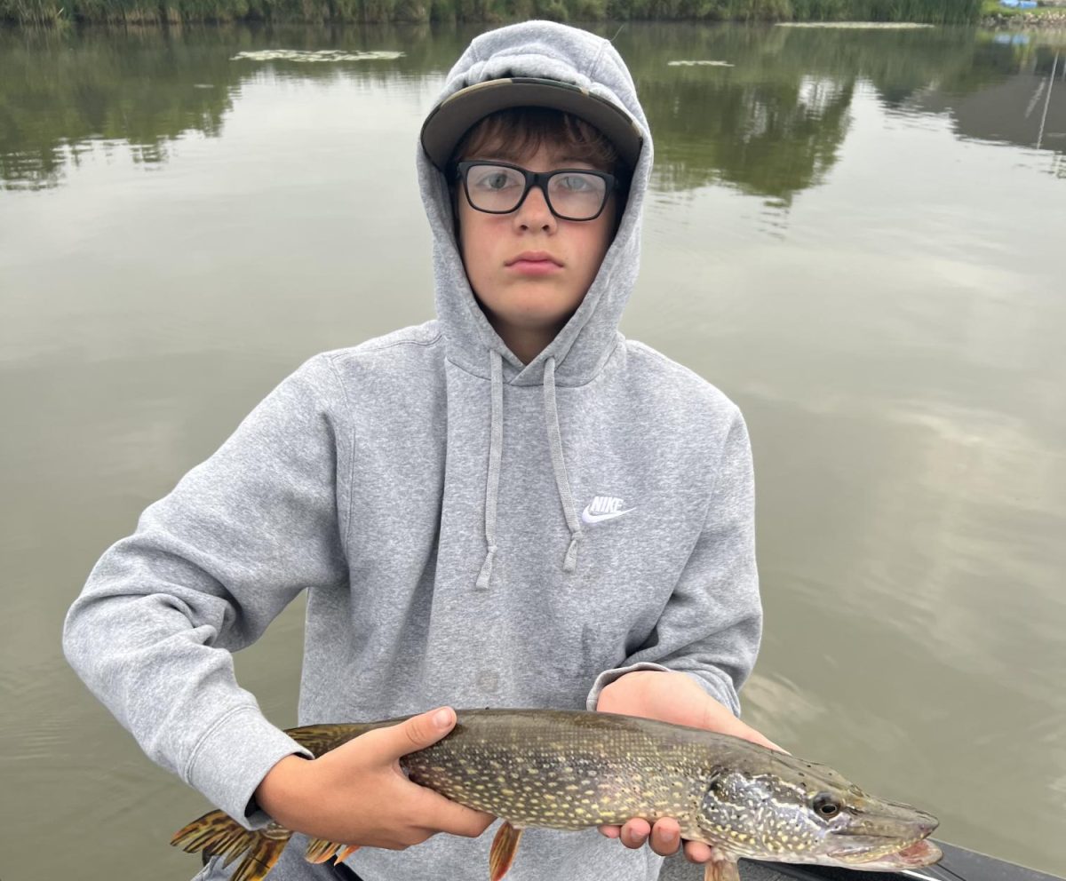 Jackson Gooding, freshman, with a fish he caught. 