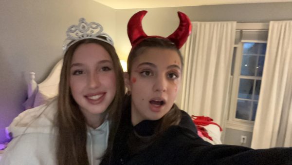 Alessandra Smeyan, freshman, takes a picture before going trick or treating with Olivia Kormanik, freshman.