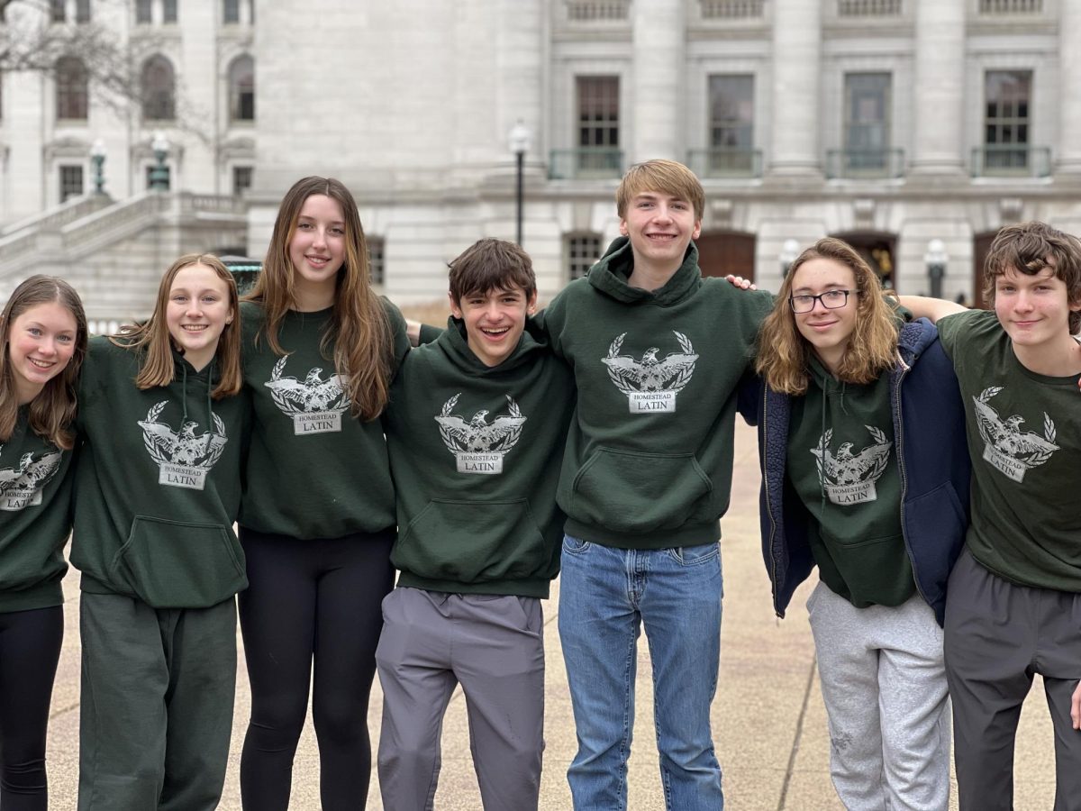 Olivia Kormanik (3rd from left), freshman, poses in front of the Wisconsin Capitol with the Latin I 2nd place Certamen team of Sarah Heller, freshman, Sayla Thierl, Misha Auchynnikau, Weston Eichmeier, sophomores, Parker Pope, and Jack Bensman, freshmen.