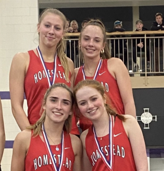Racers (from top left) Eva Brandenburg, senior, and juniors Grace Zortman, Charlotte Lueck and Shaylin Swenson smile after placing first in the 4x400 relay. 