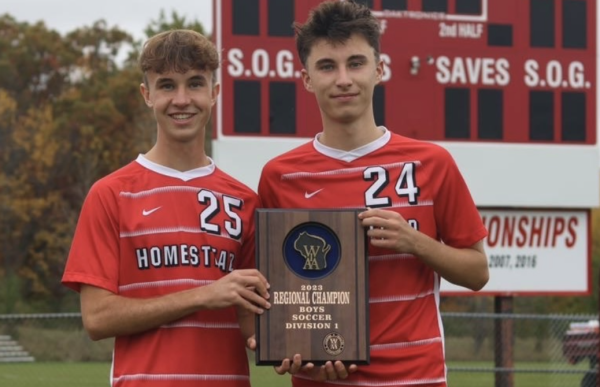 Ethan Faber, junior, and Alex Faber, junior, pose for a photo after winning the boys soccer Division 1 Regional Championship in fall of 2023. 