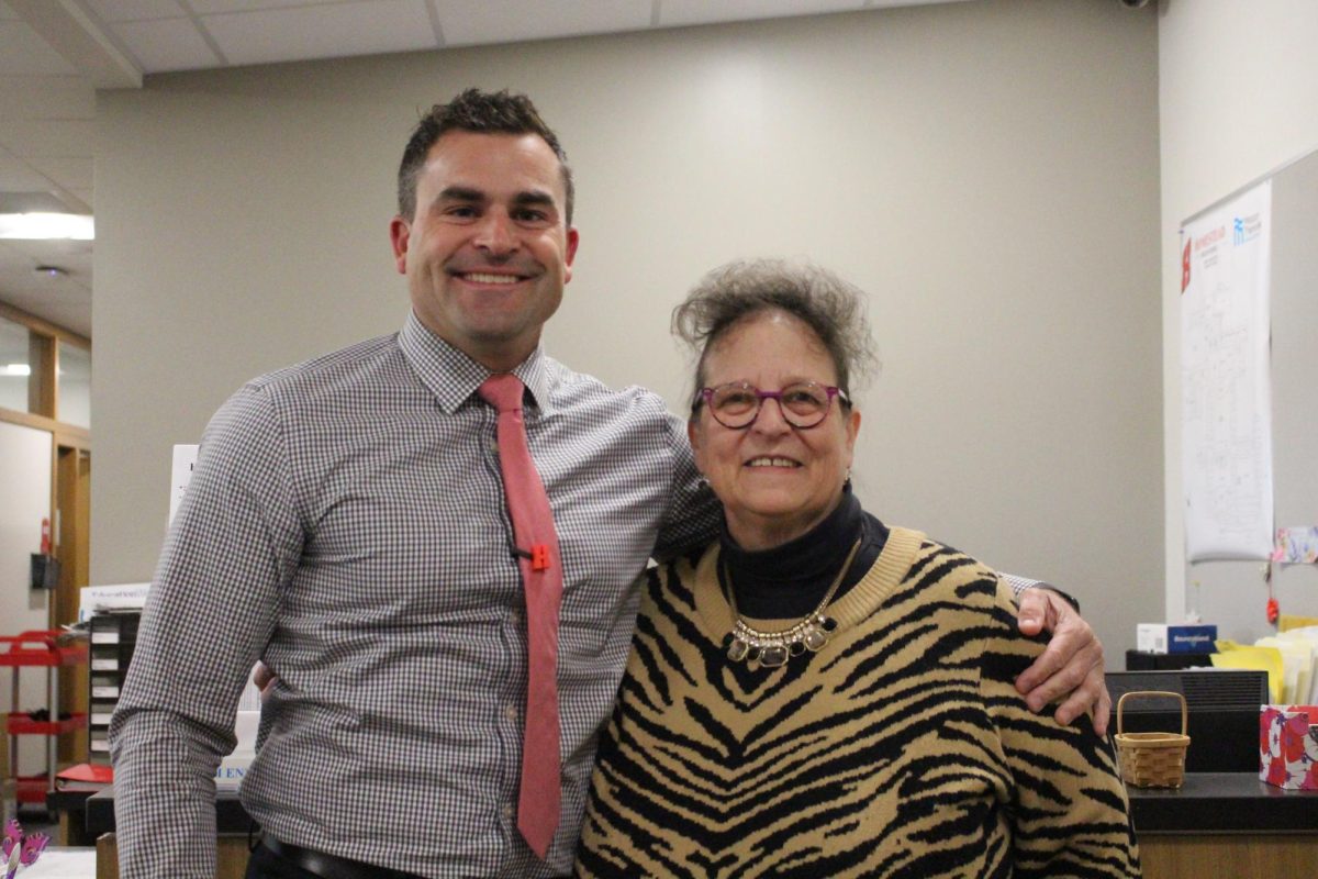 Eric Ebert, principal, and Nancy Kress, secretary, pose in the office. 