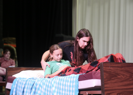 Reverend Parris, played by Erich Hartmann, senior, comforts Betty Parris, played by Tatum Lukach, freshman.