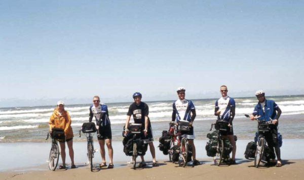 Steve (second from left) and friends dipping their bike tires in the Pacific (USAMOB).