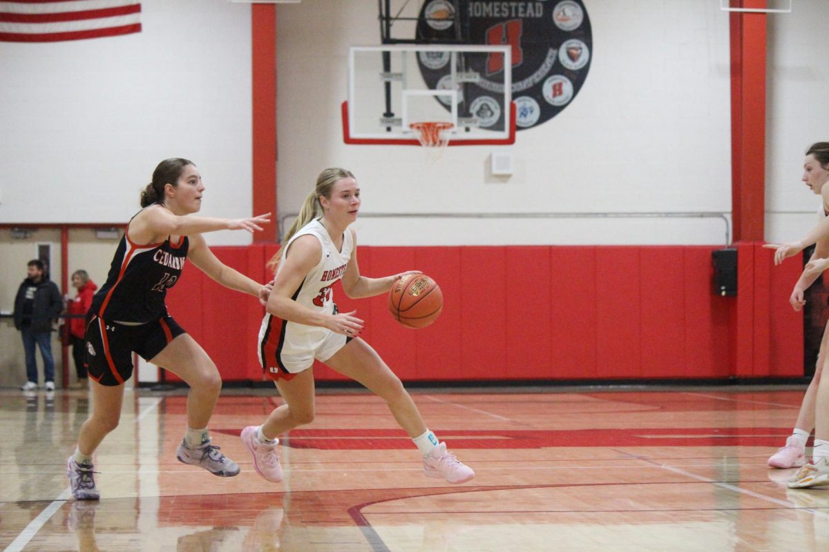 Madison Fitzgibbon, senior, dodges a Cedarburg opponent on Jan.24 in the main gym.