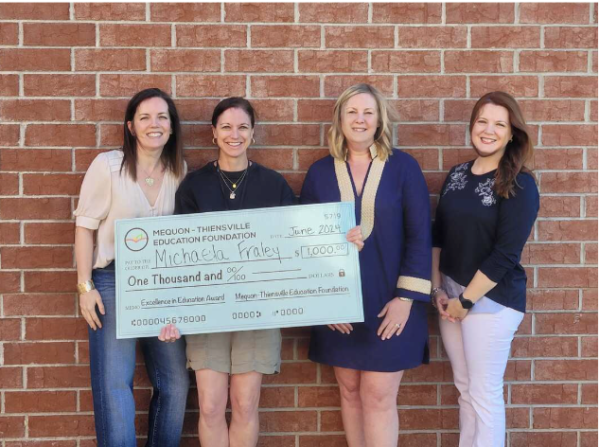 English teacher Michaela Fraley receives her check after winning the 2024 MTEF Excellence in Education Award.