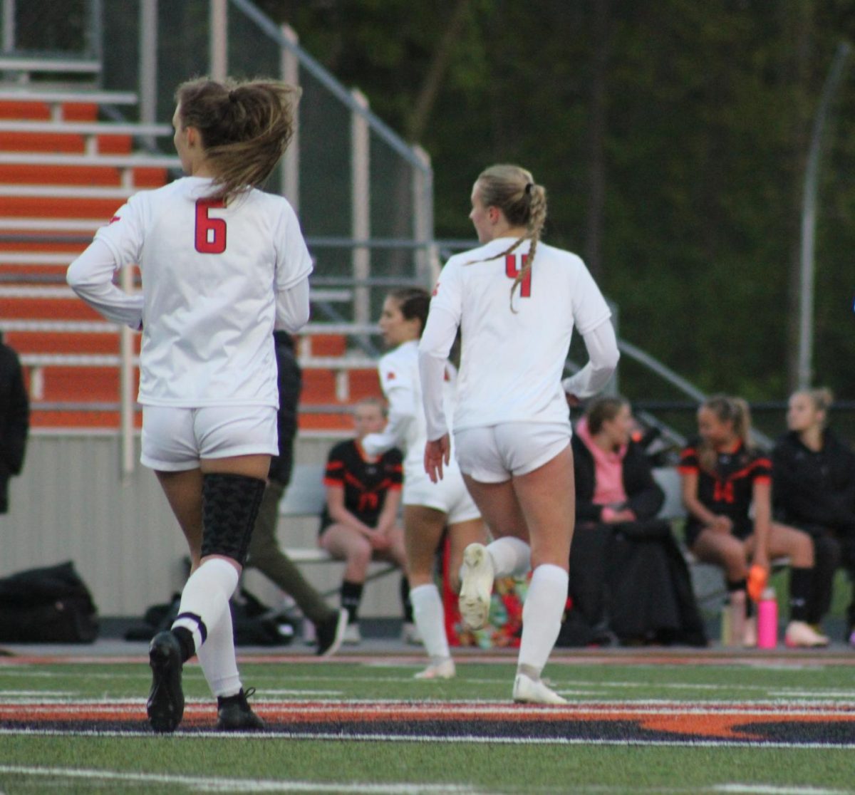 Seniors Greta Foshag and Julia Bentley hustle back to their team after a major play. 