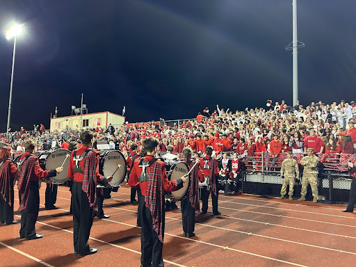 Percussion performs quarter-time performance to the student section at the homecoming game