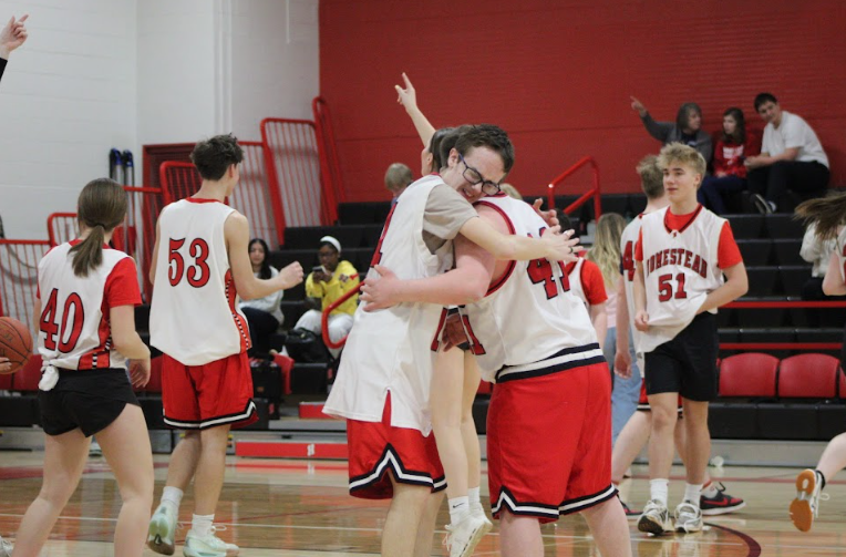 Players embrace during one of Homestead's first UBall games in the school's main gym. 