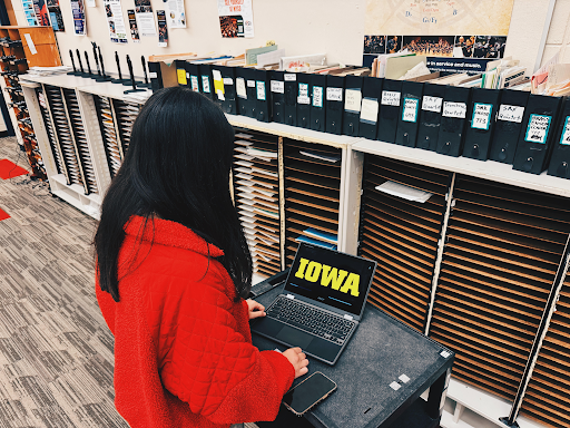 Olivia Morgan, senior, looks at the University of Iowa logo.