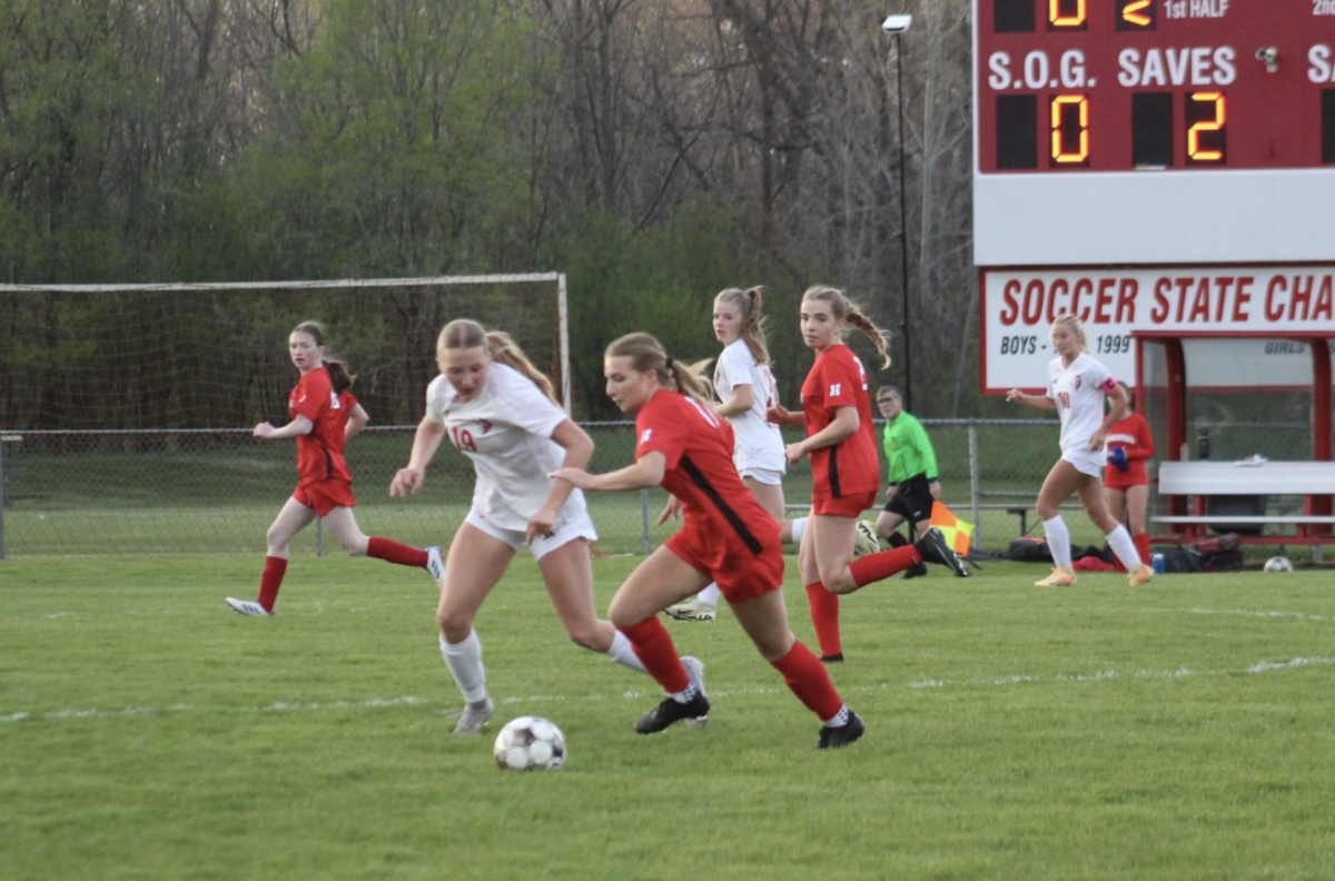 Claire Foshag, a sophomore, runs down the field with the ball against Slinger.
