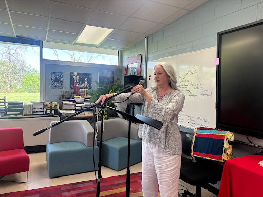 Mrs. Angelina Cicero, English Department Chair, sets up the microphone for senior graduation speech auditions. 