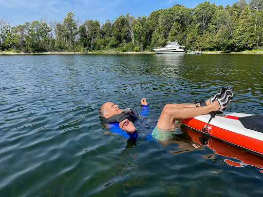 Mr. Orlando Frets lays on the Mississippi River up in Minnesota after an exhausting round of paddleboarding
