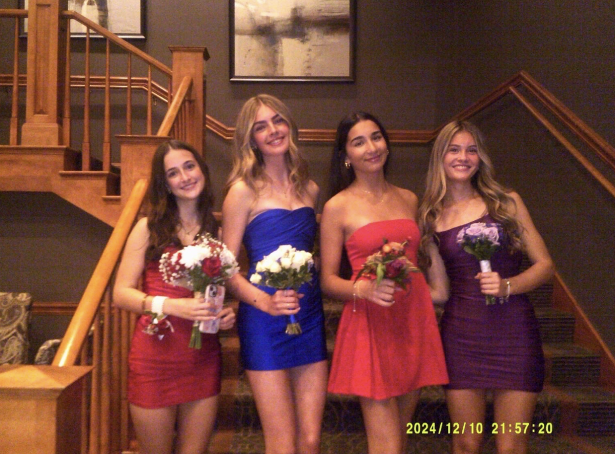 Addison Charlesworth poses with Everly Rech, Mia Bykhovsky, and Ava Raffensperger on Homecoming night. 
